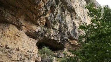 Ormanın yakınındaki kayanın doğal mağara girişinde.