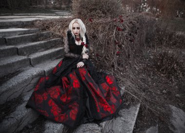 Ölü garden.ith uzun sarı saçları eski moda Kırmızı elbiseli yürürken eski moda Kırmızı elbiseli uzun sarı saçlı güzel kadın wbeautiful kadın