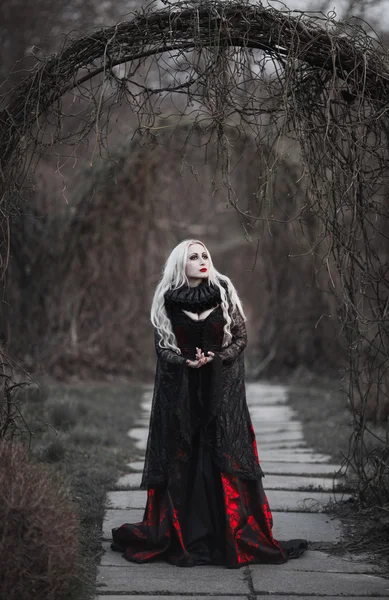 Beautiful woman with long blonde hair in old fashioned red dress — Stock Photo, Image