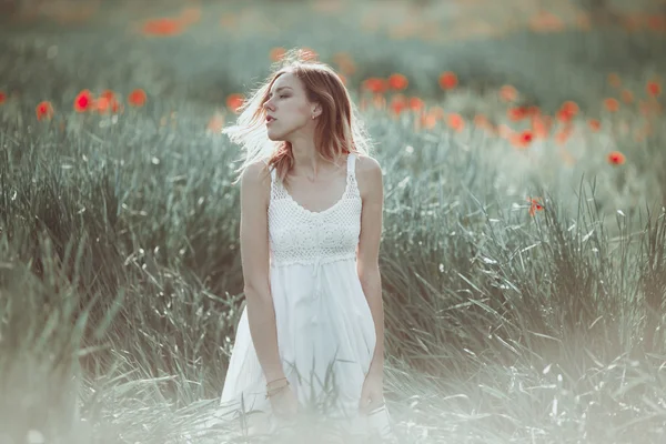 Красиві Українська дівчина з задоволенням в макового поля. — стокове фото