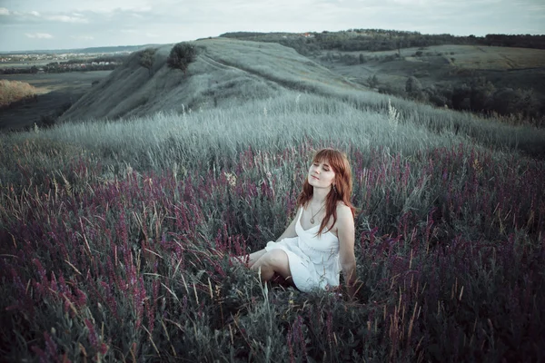 Beautiful girl in sage flower field. — Stock Photo, Image