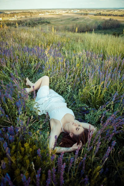 Hermosa chica en el campo de flores de salvia . — Foto de Stock