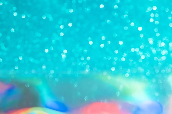 Abstract mixed holographic blue ai aqua blurred glitter shiny background. Liquid neon rainbow foil unicorn style. Bright sparkling bokeh style. Festive Christmas holiday iridescent futuristic texture