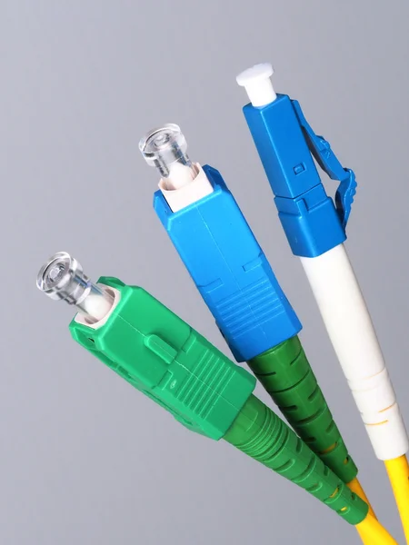 Three single fiber optic connectors used for indoor fiber optic network installation — Stock Photo, Image