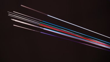 Vivid color coded Optic Fibers on black clipart