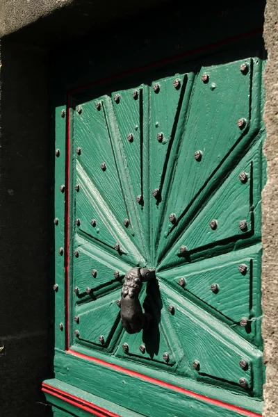 Heavy green timber house door with rustic nails and cast iron door knocker — Stock Photo, Image