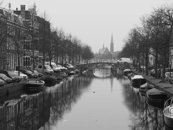 Boat lined canal with church at a cloudy but calm day — 图库照片