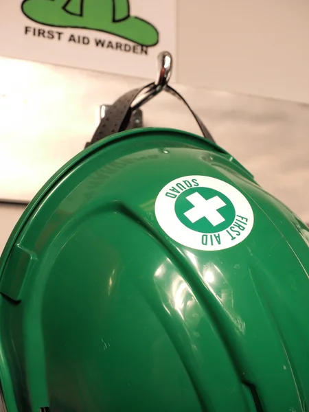 Green helmet of a first aid practitioner — Stock Photo, Image