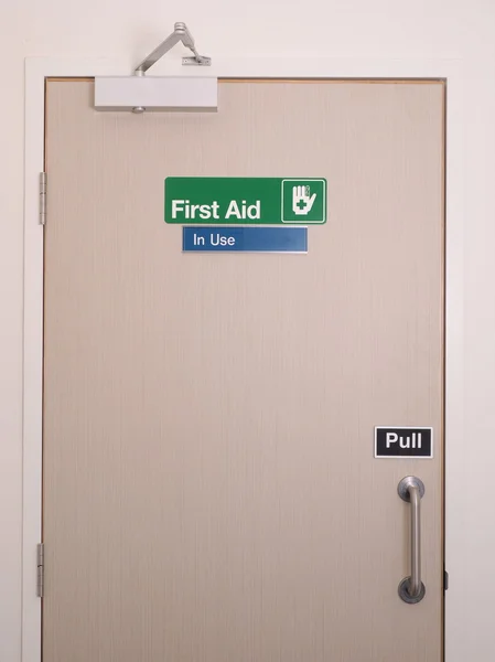First aid door and sign with occupied indicator — Stock Photo, Image