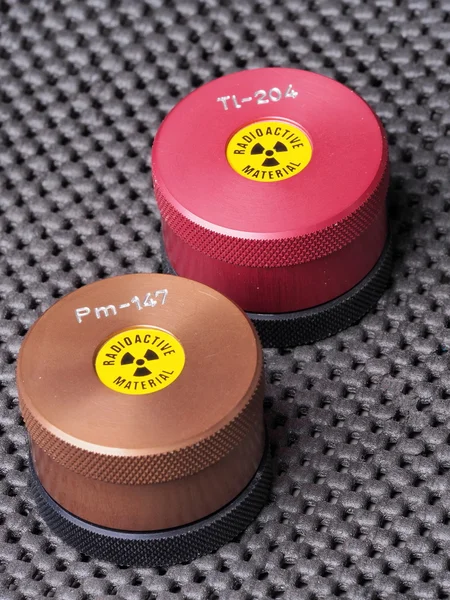 Specialist containers with warning sticker and engraving containing radioactive isotopes — Stock Photo, Image