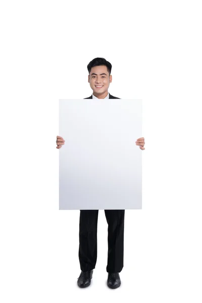 Happy young man showing placard — Stock Photo, Image