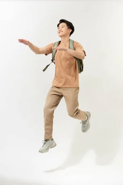 Feliz Joven Sonriente Con Mochila Saltando Aire Sobre Fondo Blanco — Foto de Stock