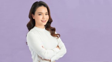 Kollarını kavuşturup gülümseyen tatlı bir kadın..