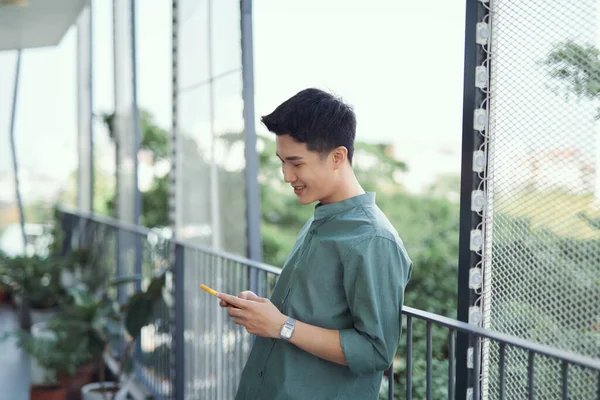 Young Man Standing Balcony Texting Mobile Phone — Stock Photo, Image