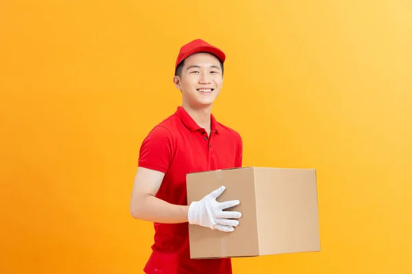 Young Smiling Delivery Man Holding Boxes Hands Happily Yellow Background — Stock Photo, Image