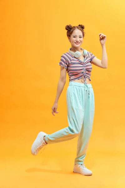 Full Length Portrait Cheerful Casual Asian Woman Jumping Isolated Yellow — Stock Photo, Image