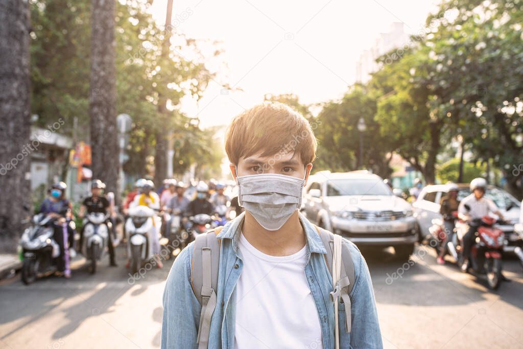 Tourist man with mask having a coffee while walking on street, travel concept in the new normal