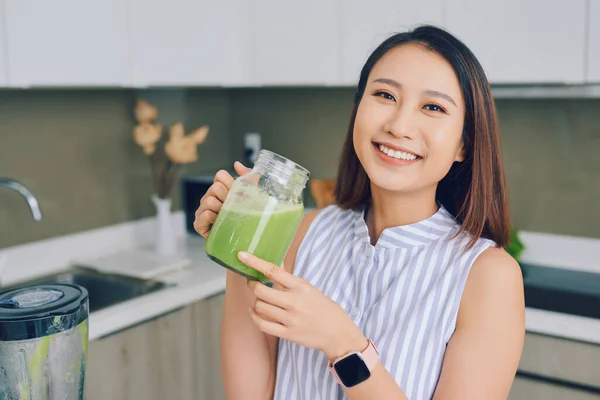 Sonriente Joven Mujer Asiática Sosteniendo Batido Verde Cocina Casa — Foto de Stock