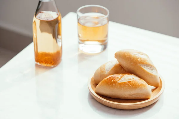 Breakfast bread with fresh apple juice on the side on white background.