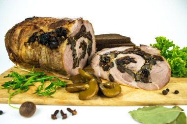 Baharat, defne yaprakları, roka ve beyaz arka planda dilimlenmiş ekmek dilimleriyle süslenmiş kesilmiş kuru erik ve mantarlı fırında köfte..