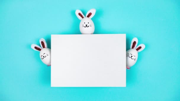 Three Easter Bunnies Made White Chicken Eggs Emerge Sheet White — Stock Video