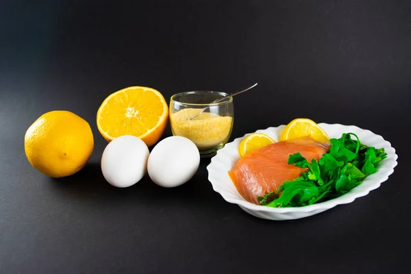 Foods containing collagen. Gelatin, eggs, fish, greens, citrus fruits containing collagen and are necessary for its synthesis for youthful skin and healthy joints. Black background. Copy space.
