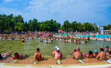 Hungary, Hajduszoboszlo - August 1, 2019: Vacationers in pools with medicinal water, tinged with natural iodine of the thermal resort spa complex Hajduszoboszlo.