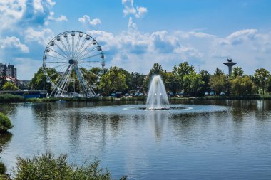 Thermal lake with a fountain in thermal health spa resort complex Hajduszoboszlo. Blue summer landscape. Hungary.