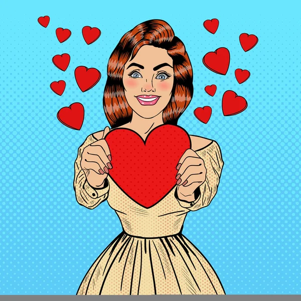 Joven mujer de arte pop bonita sosteniendo un gran corazón rojo en sus manos. Ilustración vectorial — Archivo Imágenes Vectoriales