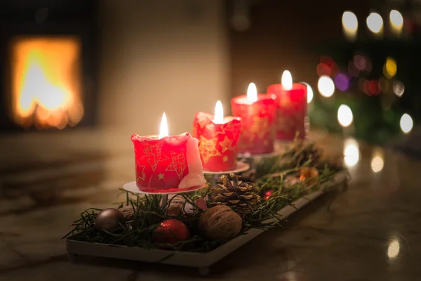 Advent candles with Christmas tree and burning chimney fire