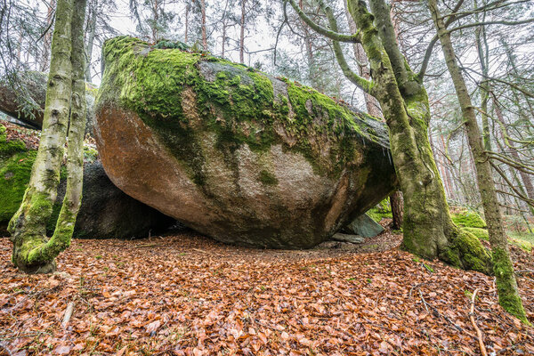 Ancient weathered megalithic granite rock formation with cave and breakthrough in Bavarian forest near Thurmansbang, Germany