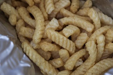 Lezzetli, çıtır çıtır karidesli kraker paketini kapat. Lezzetli, lezzetli abur cuburlar kıvrımlı, tuzlu, sağlıksız ama zevkli bir ziyafet için hazır.