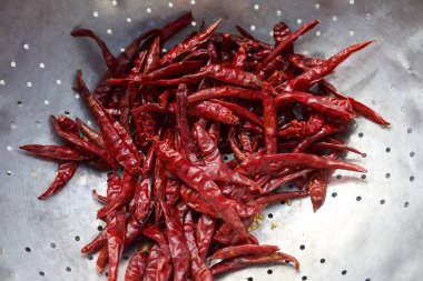 Metal nder 'da pişirmek için sıcak kırmızı kırmızı biber baharatı yığını. Baharatlı kırmızı yemek, sıcak ve lezzetli yemekler için anahtar bileşen.