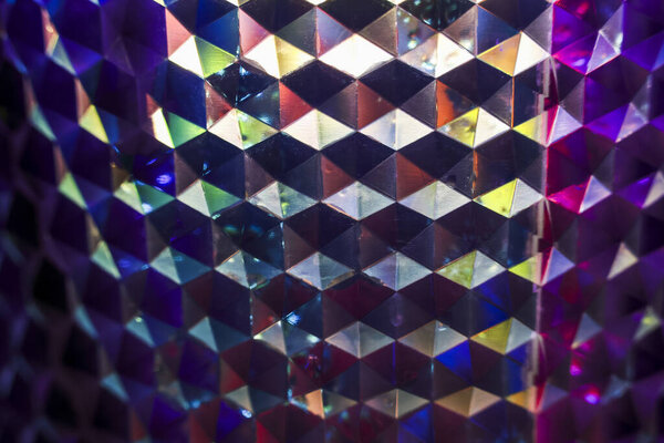 Mesmerizing abstract background with holographic geometric pattern. vibrant, iridescent surface reflects light, creating shimmering, colorful, and psychedelic effect