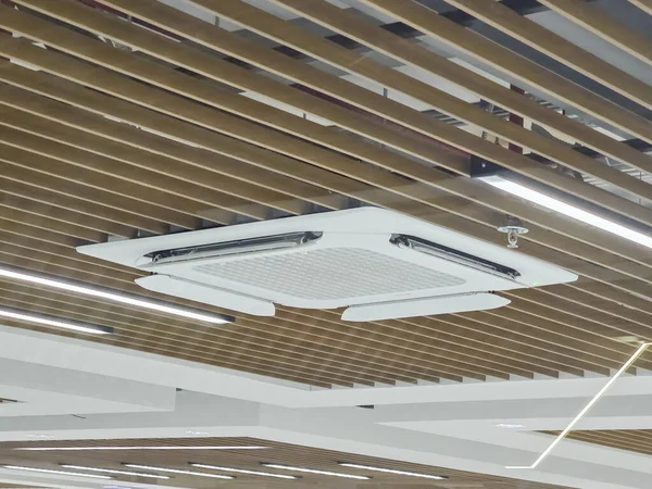 Modern beyaz tavan kaset klima soğutma ofisi ahşap slat tasarımı ve doğrusal ışıklandırma kapalı alanda üretken çalışma ortamı için rahat profesyonel atmosfer oluşturur