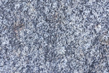 Top view of rough gray granite stone texture with black spots showing strong and durable abstract surface pattern suitable for heavy wall floor background or construction material design