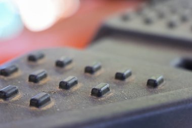 Ev ortamında televizyon veya elektronik cihazlarda kullanılan siyah kauçuk tuş takımında tozlu dokuyu gösteren kirli uzaktan kumanda düğmesini kapat