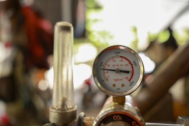 Endüstriyel ekipmanlardaki basınç göstergesini ve düzenleyiciyi kapatın. Doğru kontrol ve gücü gösteren, gaz akışını ölçen iğneli hassas bir alet.