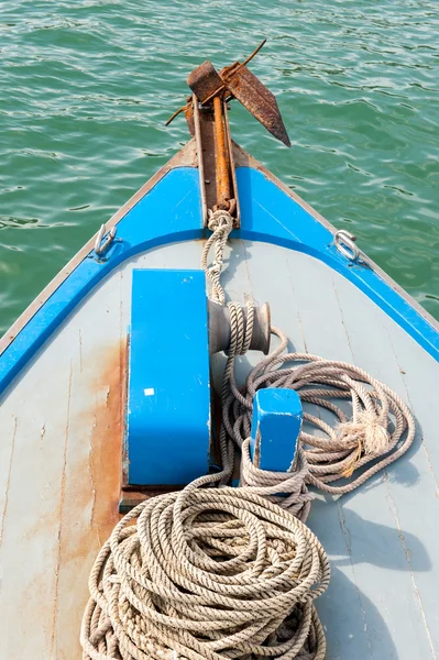 Rostiger Anker an der Front eines blauen Holzbootes — Stockfoto