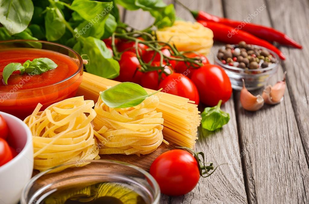 Pasta, vegetables, herbs and spices for Italian food on the rustic