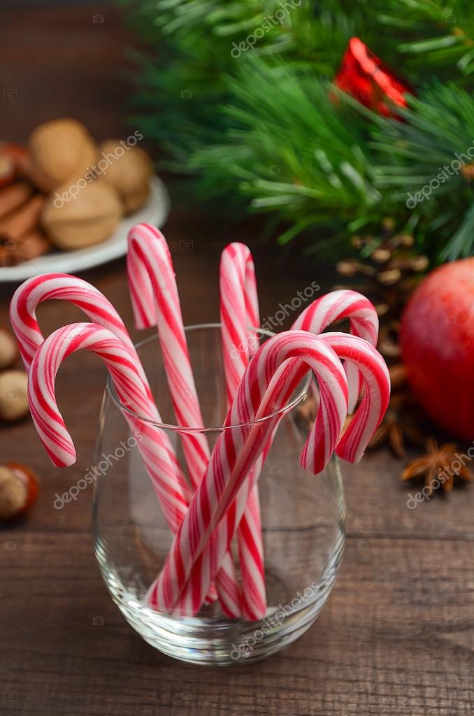 Peppermint Candy Canes And Other Christmas Decorations On Wooden