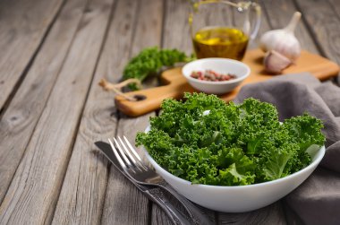 Fresh kale with olive oil, garlic and pepper clipart