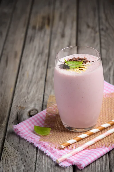 Smoothie de morango e banana com aveia na mesa de madeira rústica . — Fotografia de Stock