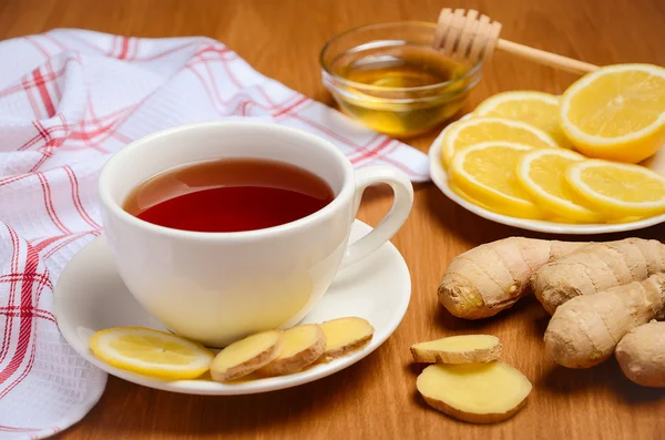 Black tea with lemon, ginger and honey on the wooden table. — Stock Photo, Image