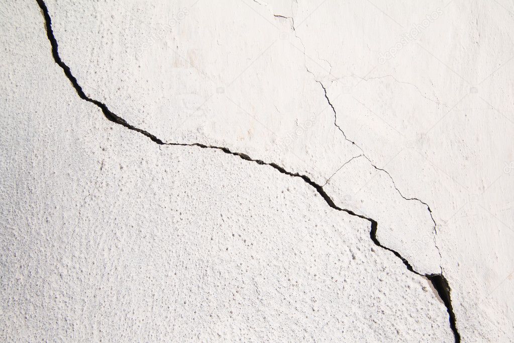 Crack. Texture of old painted white plaster. Cracked wall.