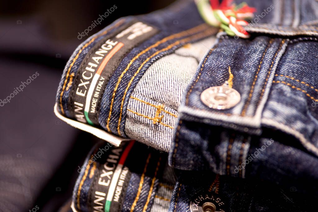 Berlin, Germany - September 25, 2020: Folded Armani Exchange denim jeans on a store shelf
