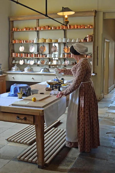 Victorian Kitchen maid - Cook preparing food .in authentic Victorian kitchen. — Stock Photo, Image