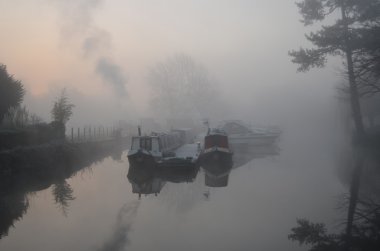 Narrow Boats in the early morning fog clipart