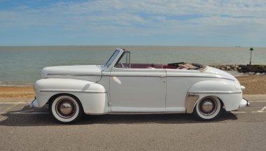 Classic Ford Super Delux motorcar in show on seafront.