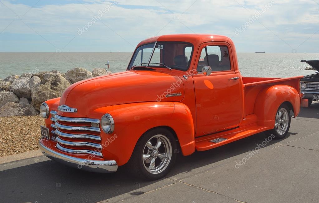 Classic Bright Orange Chevrolet pickup truck on Felixstowe seafront